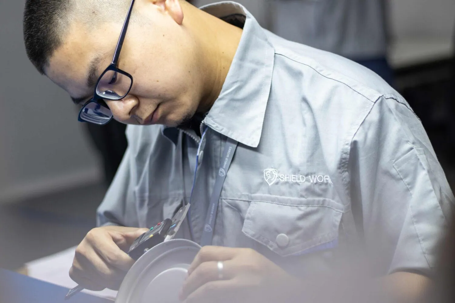C2W quality engineer measuring a component with digital calipers